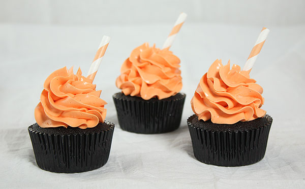 Chocolate Pumpkin Spice Cake from Grace's Sweet Life A photo of Chocolate Pumpkin Spice Cakes decorated with orange-tinted Vanilla Bean-Swiss Meringue Buttercream and orange and white striped straws.