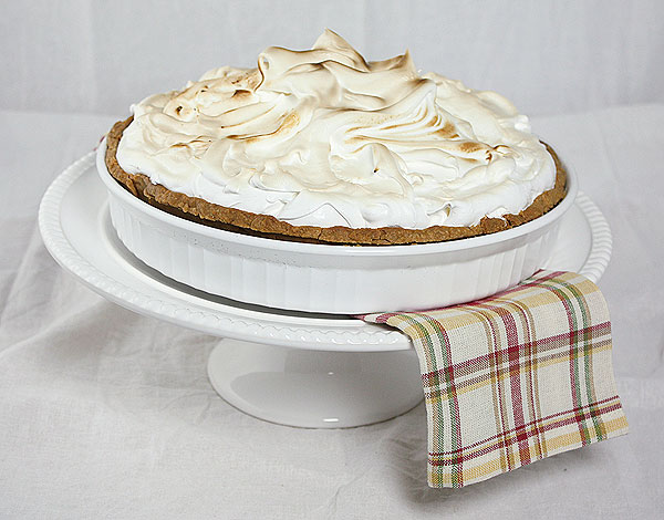 A photo taken looking down on a Lemon Meringue Tart with swirls of Italian Meringue.