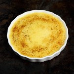 A photo taken looking down on Baked Lemon Custard in a white flan dish.