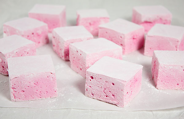 Close up photo of Gourmet Strawberry Marshmallows displayed on sheet of baking paper.
