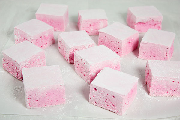 A photo of Strawberry Guimauve randomly placed on baking paper.