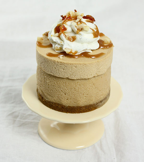 Close up photo taken looking down on a Mini Dulce de Leche Cheesecake on small yellow cake stand.