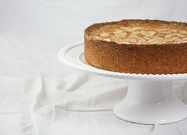 Close up, cropped photo of Blackberry-Almond Shortbread Cake displayed on white cake stand.