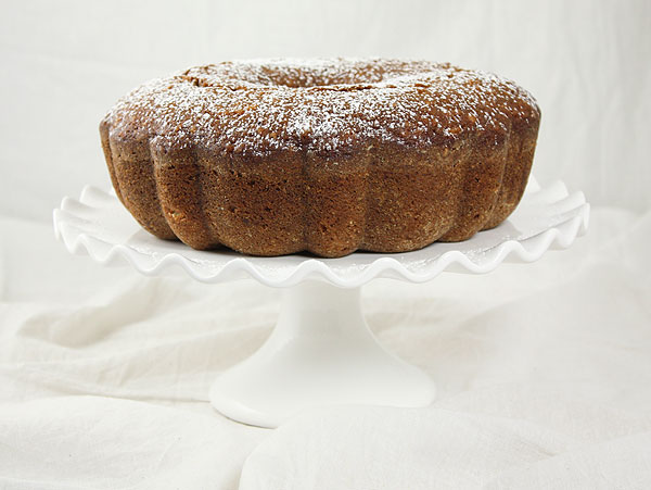 Close up photo of Pear Quick Bread on a white cake stand.